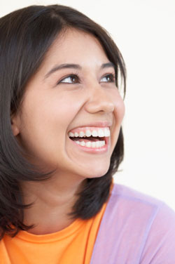 Woman smiling with hands on her cheeks