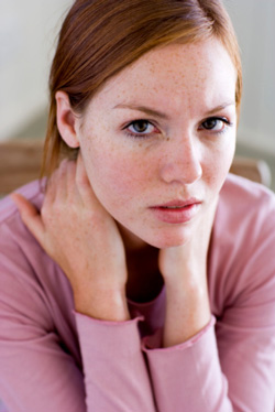 woman with hands on the back of her neck