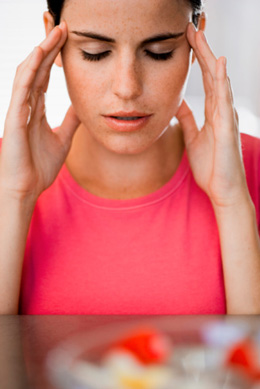 woman with hands on temples