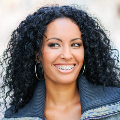 Adult woman wearing traditional metal braces