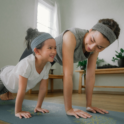 mom and daughter doing yoga