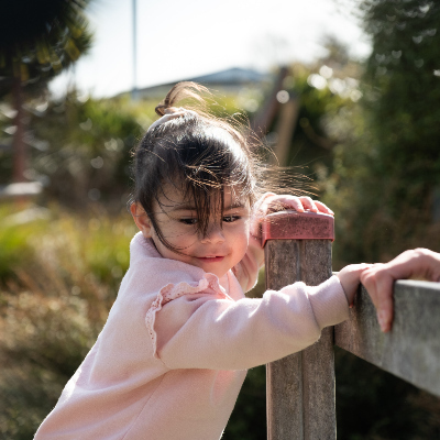 Girl climing on fence