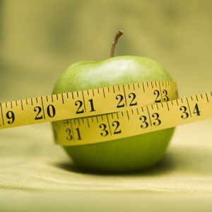 Apple with tape measure around it