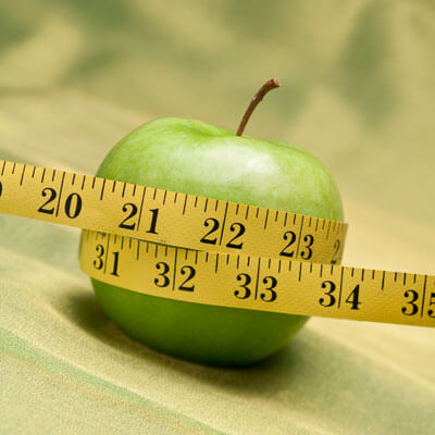 Apple with tape measure around it