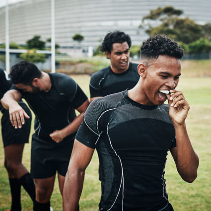 athlete putting in mouthguard