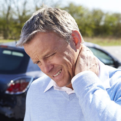 Man holding neck in pain after accident