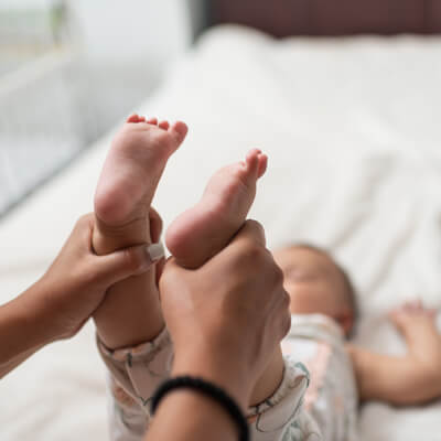 person holding baby's feet in their hands