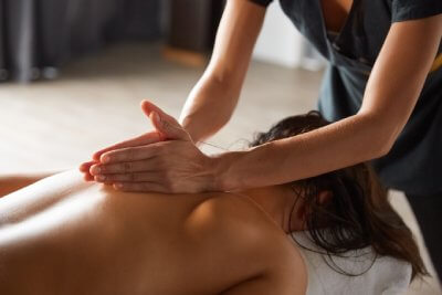 Female patient treated with Massage Therapy