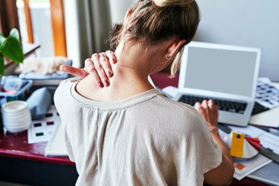 Woman holding neck in pain