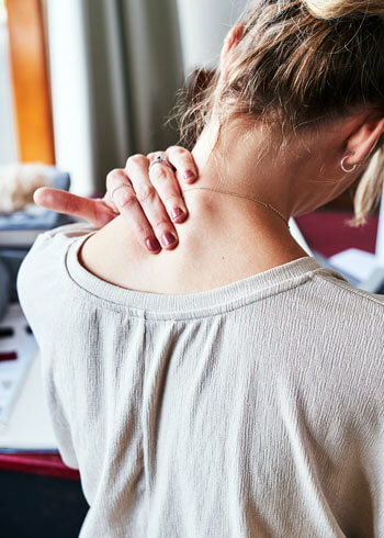 back of woman with neck pain