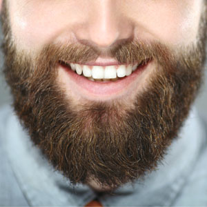 Close up of a bearded man's perfect smile.