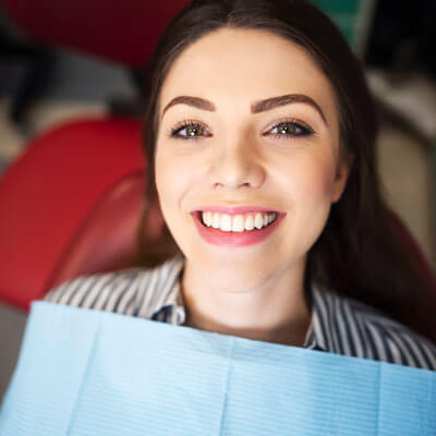 Woman with beautiful smile at dentist