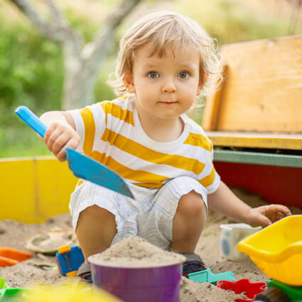 Little boy playing with his toys