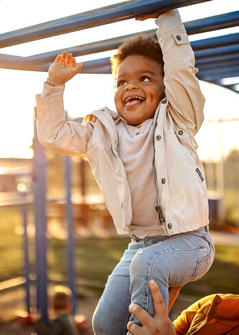 Boy playing on monkey bars