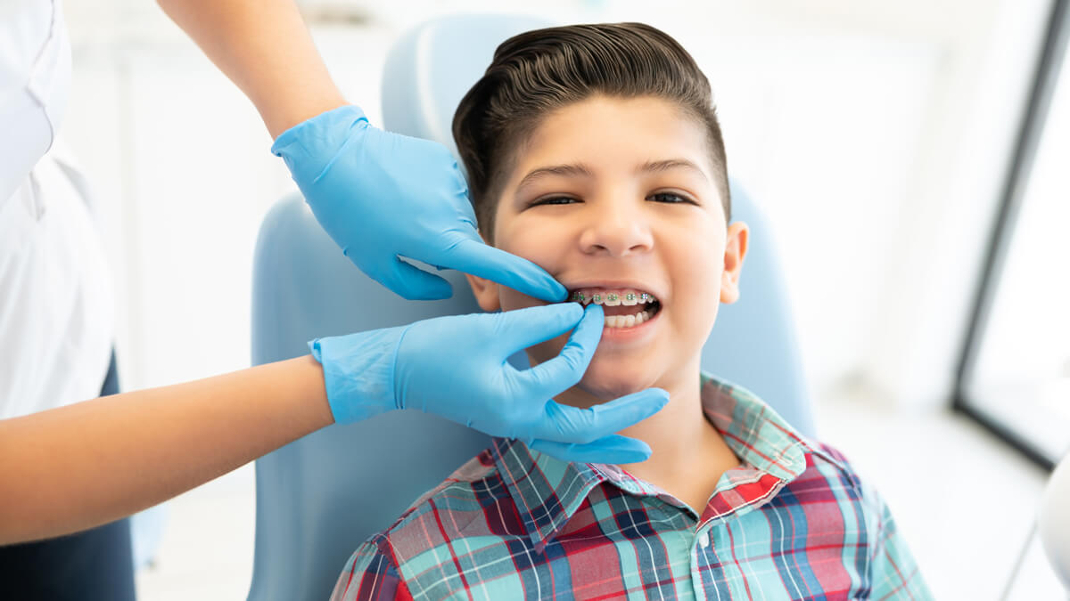 boy with braces sitting in dental chair