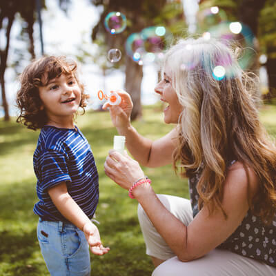 happy mom and kid playing outdoors