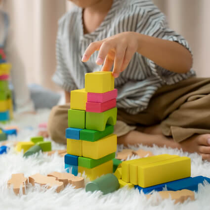 child playing with blocks and toys