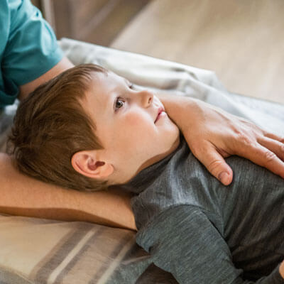 smiling child during a chiropractic adjustment