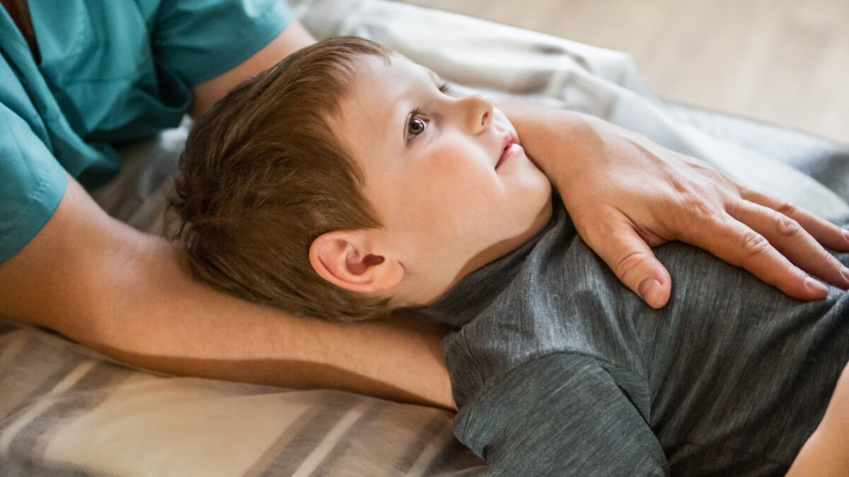 Boy laying on adjusting table