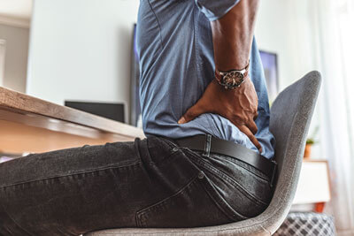 Man in chair with back pain