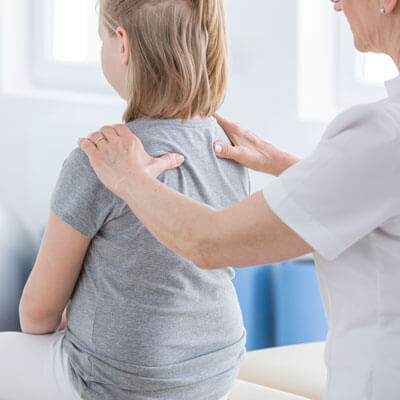 checking girl spine for posture