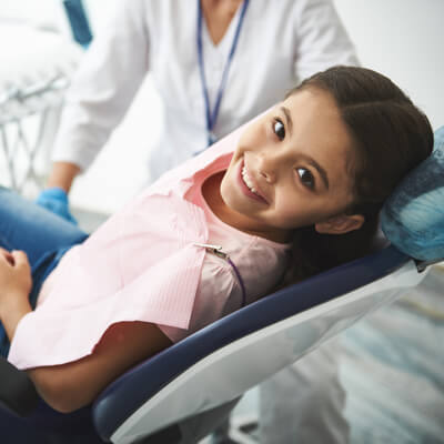 child smiling in dentists chair