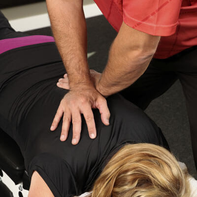 Doctor adjusting woman on table