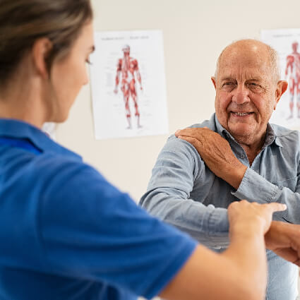chiropractor examining mans shoulder