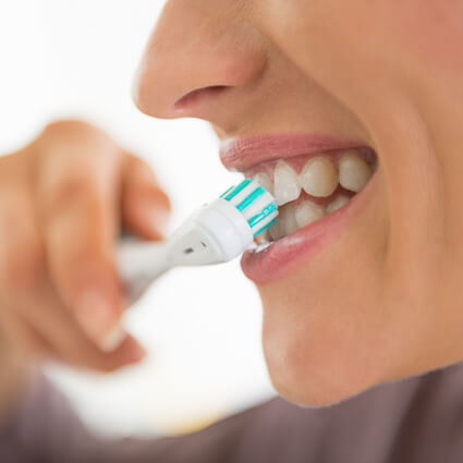 woman brushing teeth