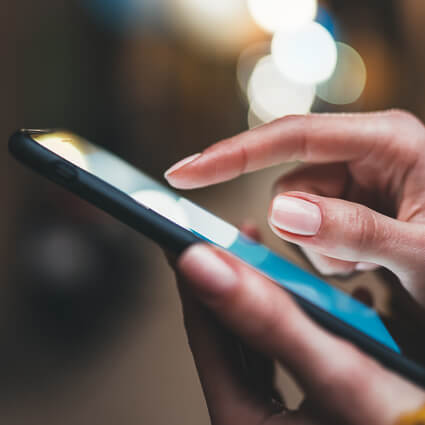 close-up of finger scrolling phone