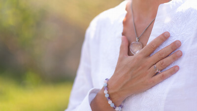 Woman with hand on chest