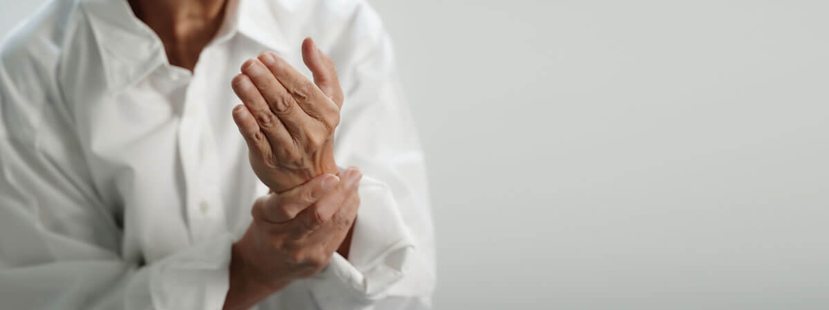 Woman holding wrist