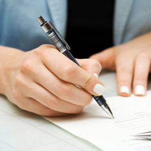 Person signing paper
