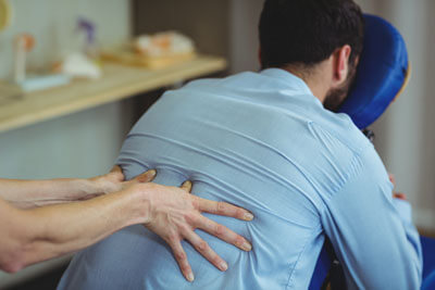 Male patient receiving a back massage