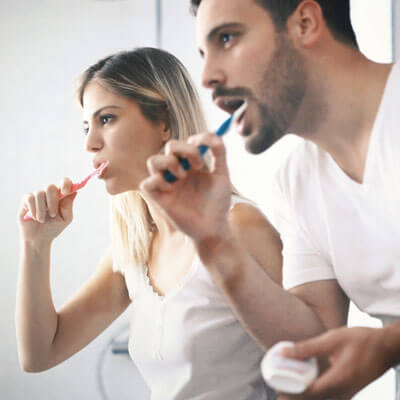 Couple brushing their teeth