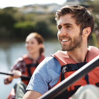 couple kayaking yellow oars