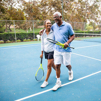 Older couple playing tennis