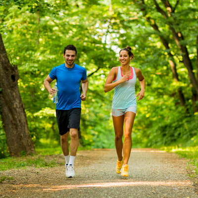 Two people running in a park