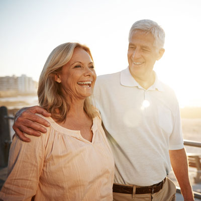 A happy senior couple outside enjoying the sunshine.