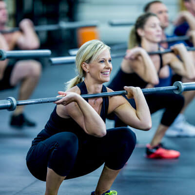 smiling woman lifting weights