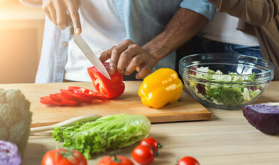 Man cutting up peppers