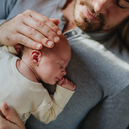 Baby sleeping on dad