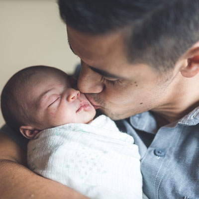 Dad kissing baby