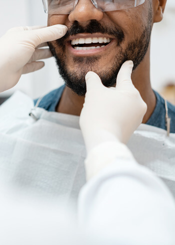 dentist checking man's smile