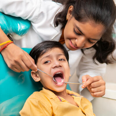 dentist checking childs  teeth