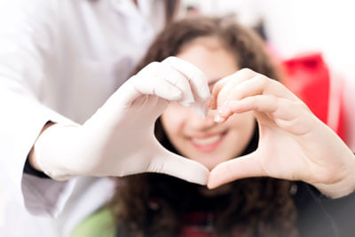 dentist patient heart hands