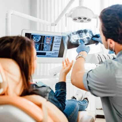 showing dental x-rays to patient