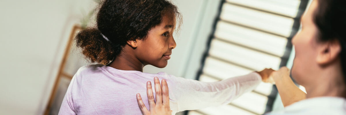 Chiropractor adjusting a child's arm