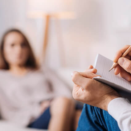 therapist writing notes