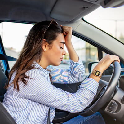 Woman sad, sitting in car